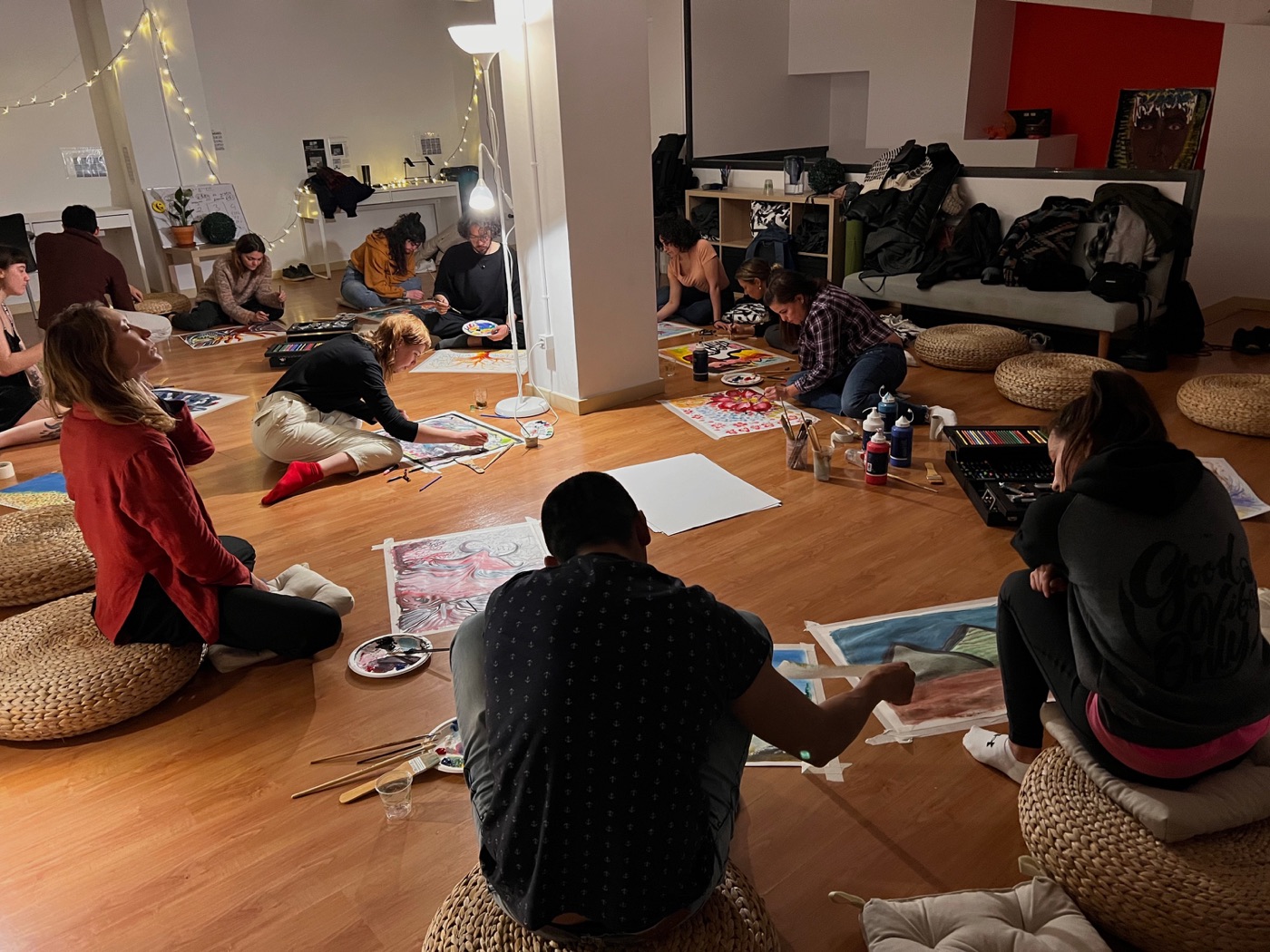 Artists drawing together on the floor during a Co-Create session